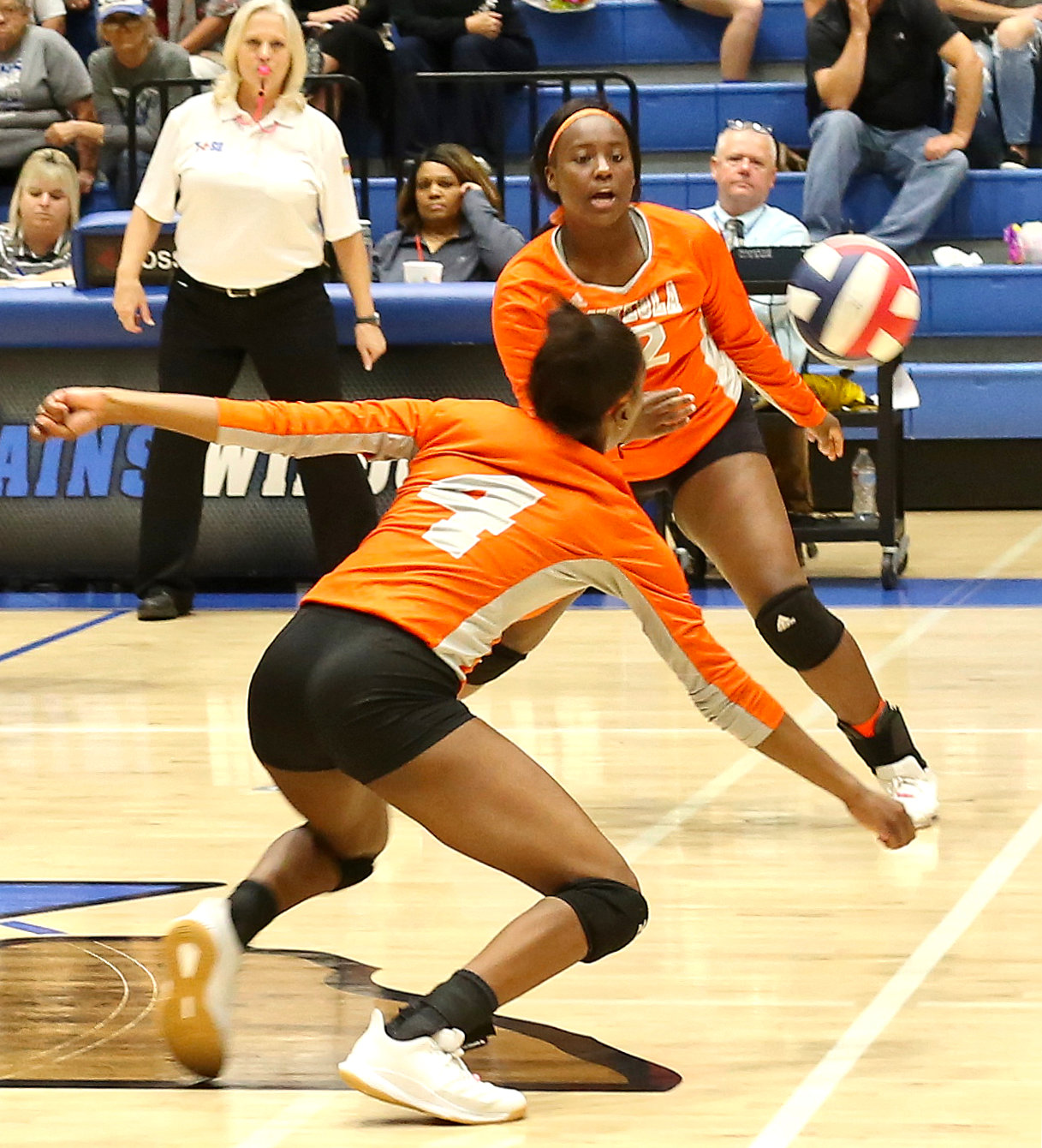 Mineola’s Tahjae Black and Tiara Stephens react to a drop shot in action against Rains.